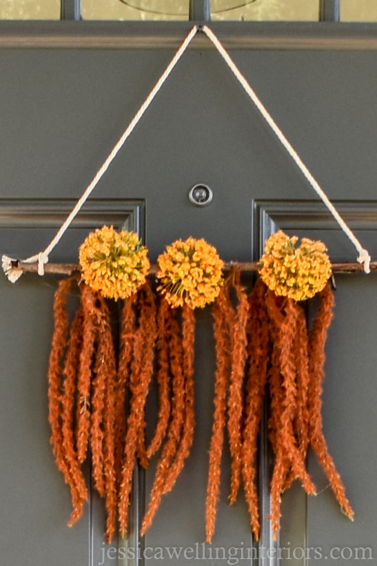 close-up of an easy DIY Boho wreath wall hanging on a front door for Fall