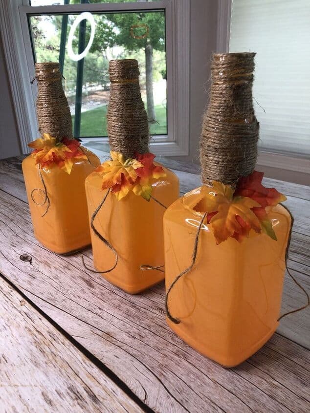 close-up of 3 bottles decorated to look like pumpkins for Fall decor