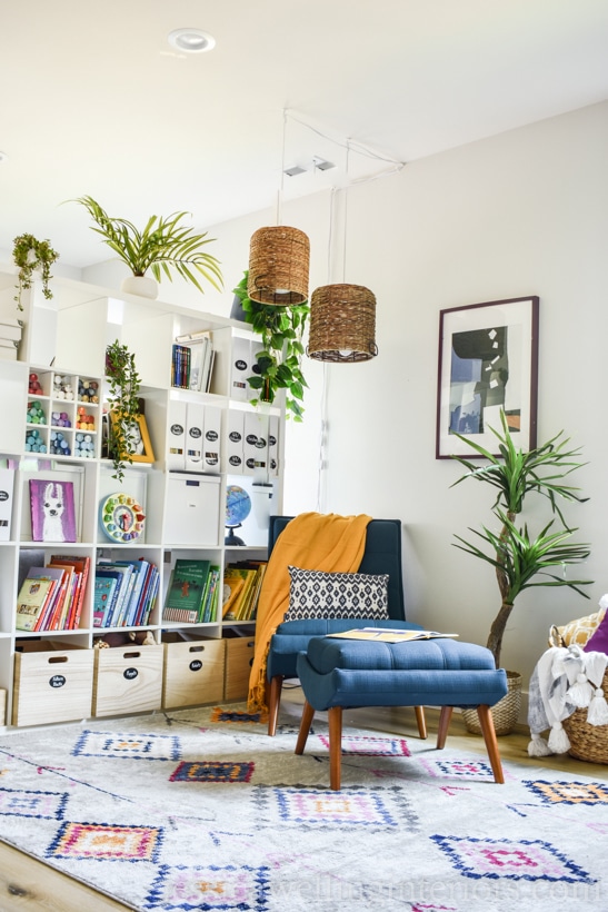 colorful home office design with a reading nook including a modern rug, Ikea Kallax bookcase, and midcentury lounge chair