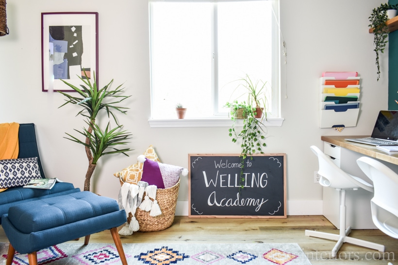 finished homeschool room with a chalkboard sign that reads, "Welcome to Welling Academy", a distance learning desk, rug, and reading nook