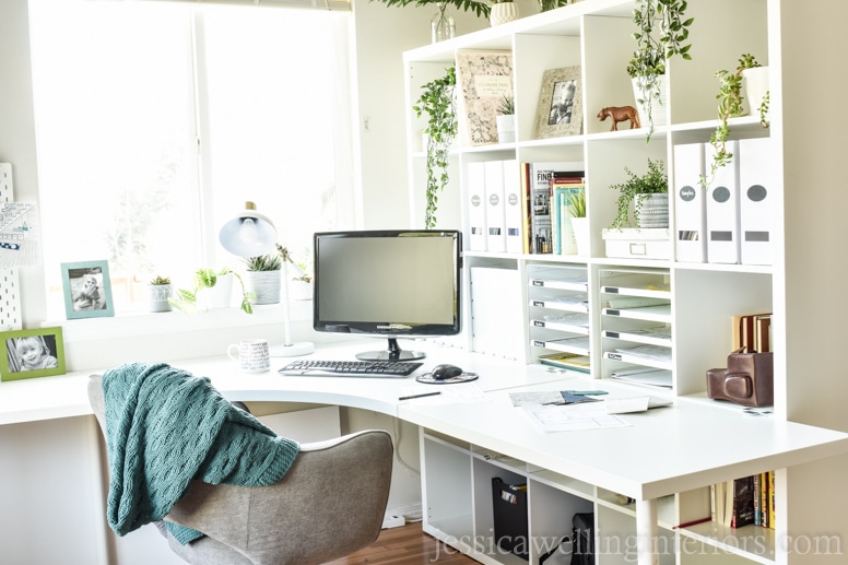 modern home office design with a white corner desk and Ikea Kallax bookshelf and a lot of natural light from a window