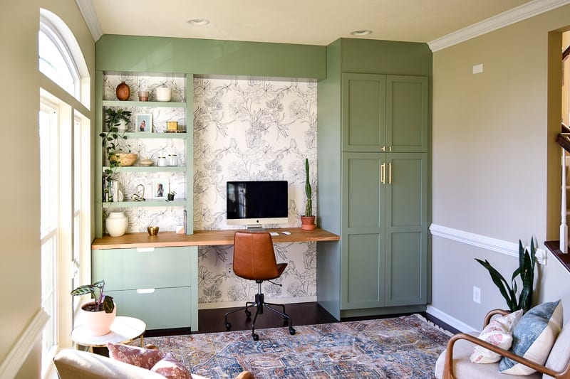 light green Ikea-hacked desk wall with built-in storage, bookshelf, and file cabinet. 