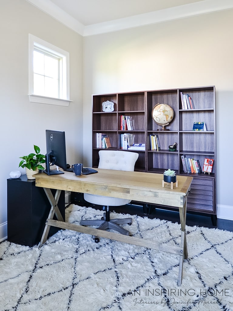 transitional home office design with a wood desk and bookcase backdrop for Zoom meetings