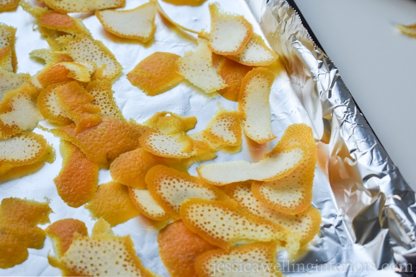 bits of orange peel on a foil-lined cookie sheet, ready to go into the oven