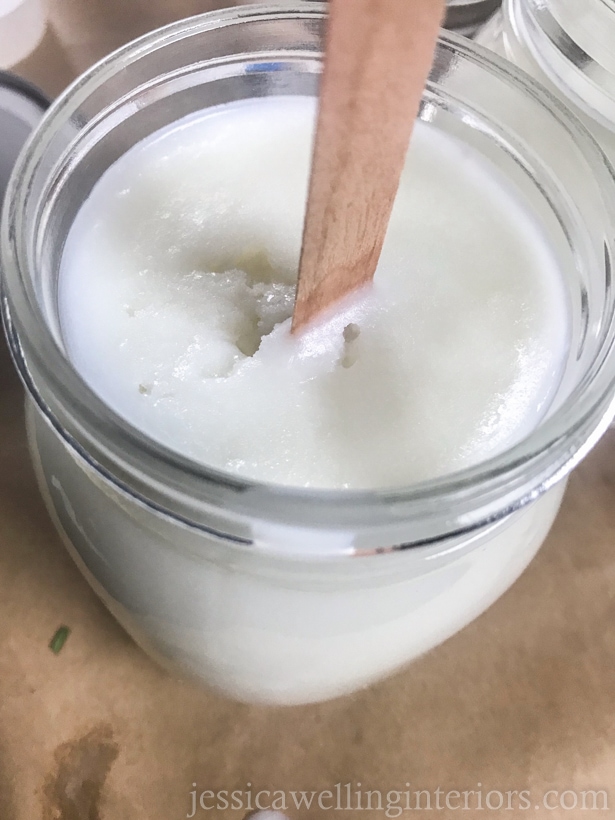 close-up of a wood wick candle in a large glass jar. 