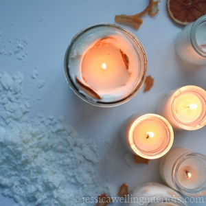 overhead view of glowing soy candles on a white background