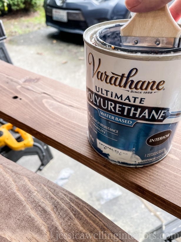 can of polyurethane top coat being applied to a DIY coat rack