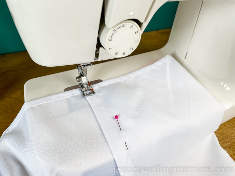 close-up of a patio curtain panel being hemmed with a sewing machine