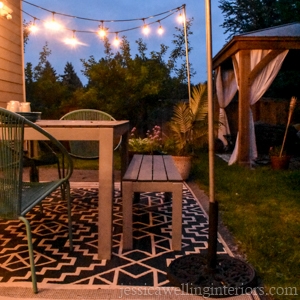 patio with a DIY string light pole in an umbrella base