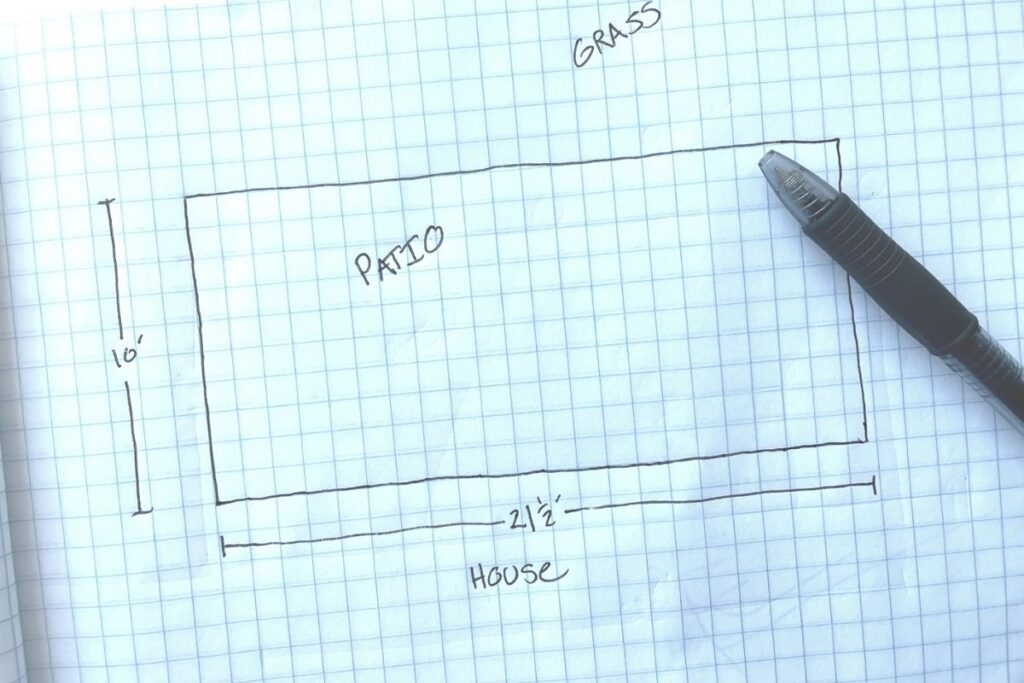 hand-drawn map of a patio on graph paper to plan string light layout