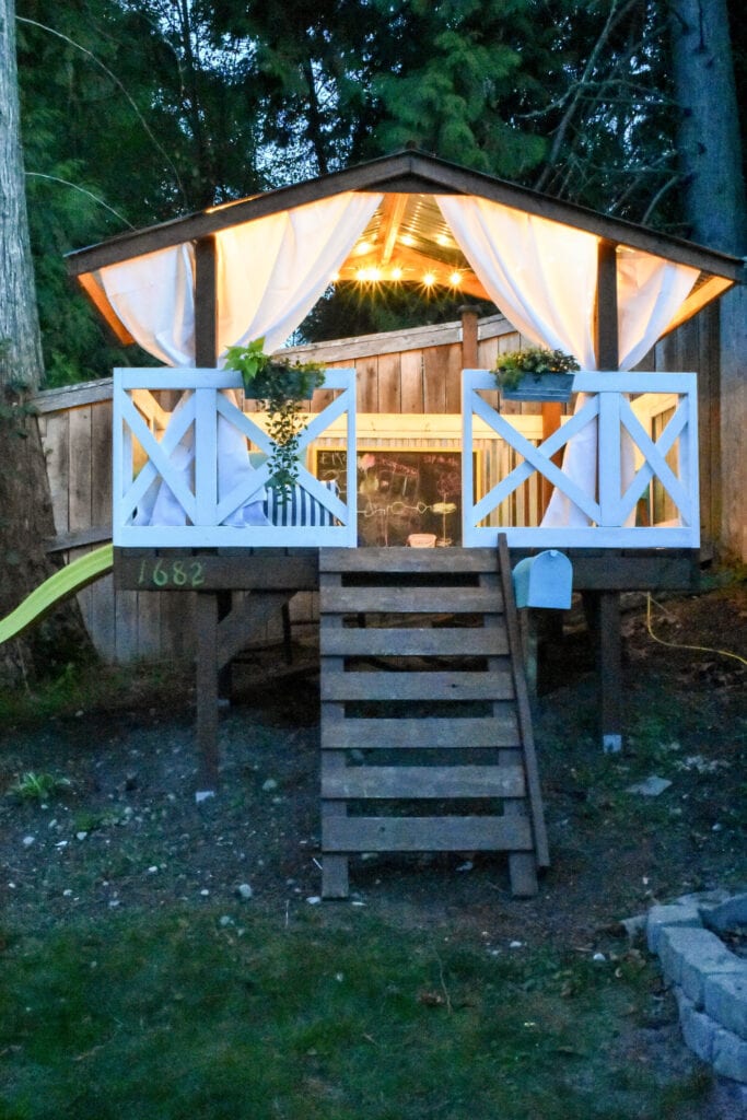 glowing string lights hung under the roof of a children's playhouse