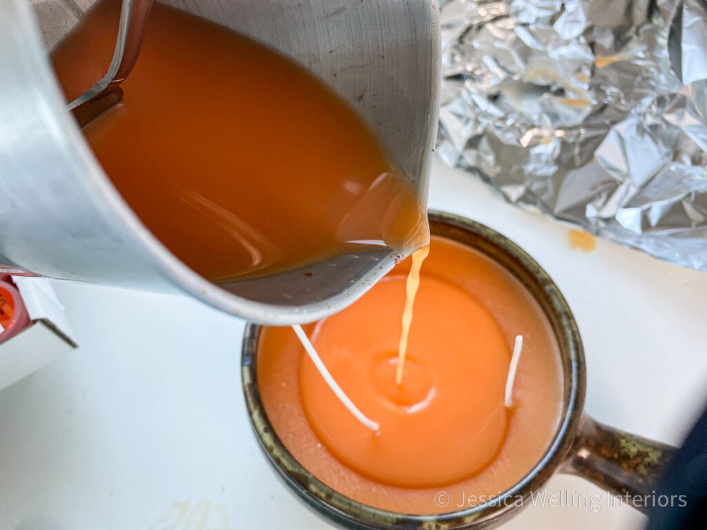 second layer of wax being poured to cover the top of a scented candle for Fall