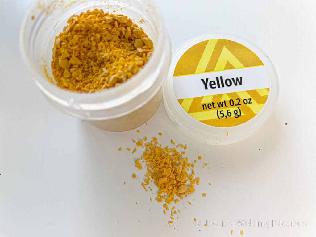 yellow candle dye chips in a container
