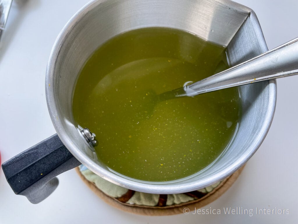 pitcher of melted yellow candle wax