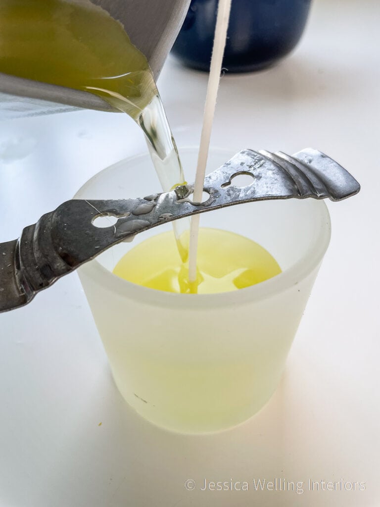 hot wax being poured into a votive candle jar to make a DIY citronella candle