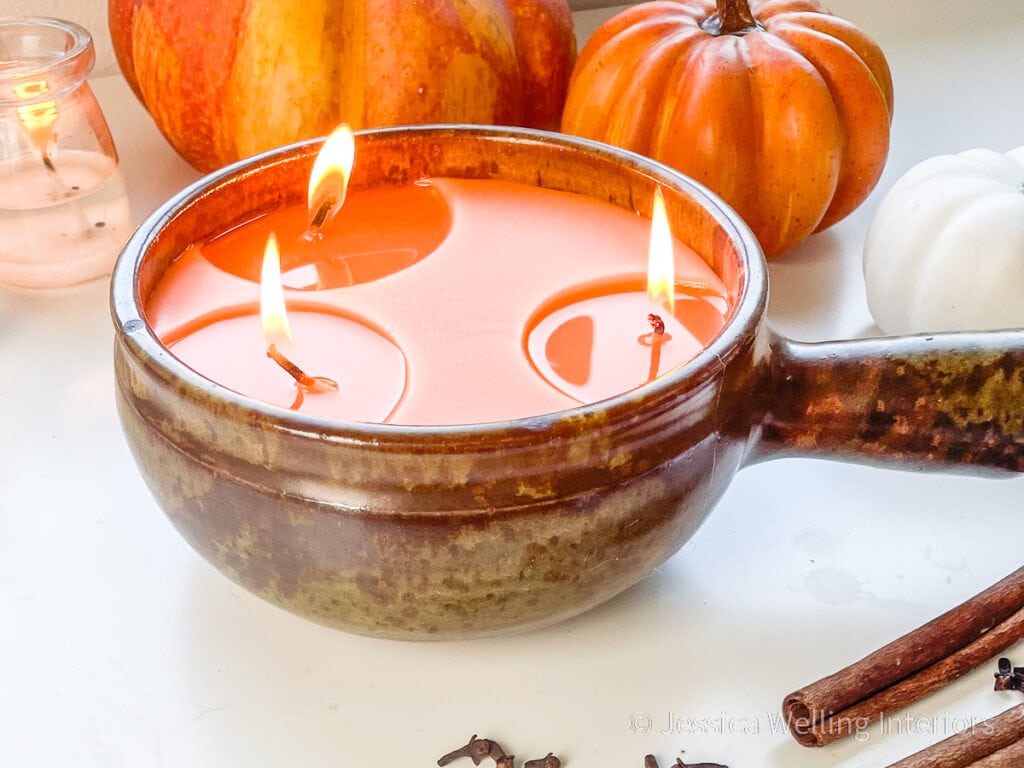 large orange 3 wick candle made with Pumpkin Harvest fragrance oil burning with pumpkins and cinnamon sticks