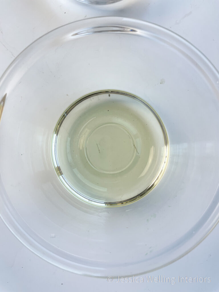 overhead view of a glass bowl of melted soy wax