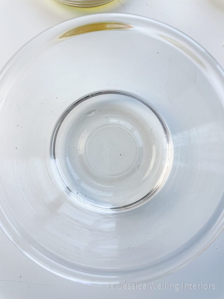 overhead view of glass bowl with clear melted paraffin wax in it