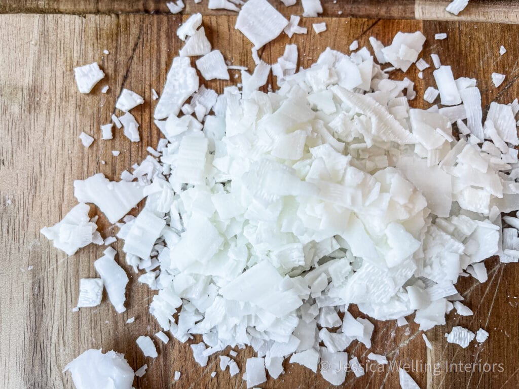 close up of soy wax flakes on a wood cutting board