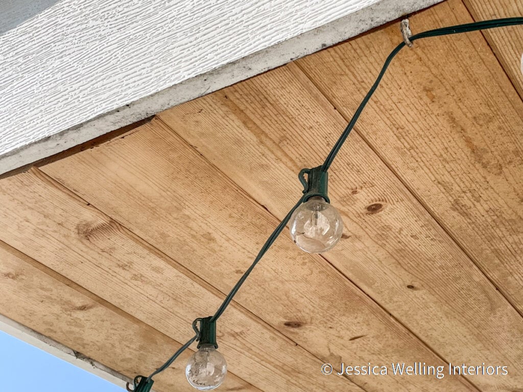 close-up of string lights attached to the underside of a roof