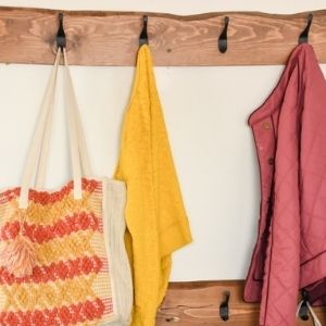 DIY wall hooks with coats and a purse