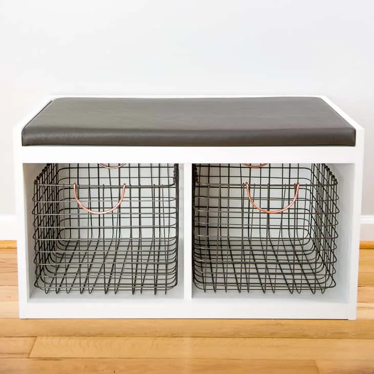 DIY shoe storage bench painted white with wire baskets