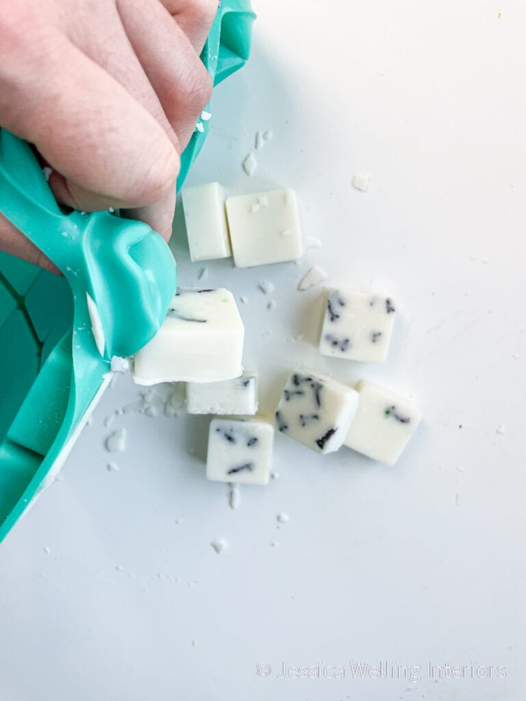close-up of wax melts being popped out of a silicone mold