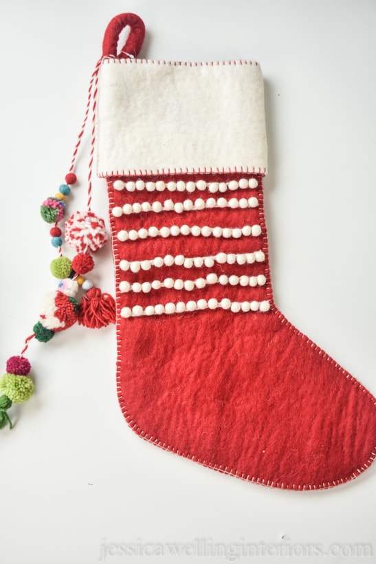 Boho red Christmas stocking with colorful tassels and pom poms