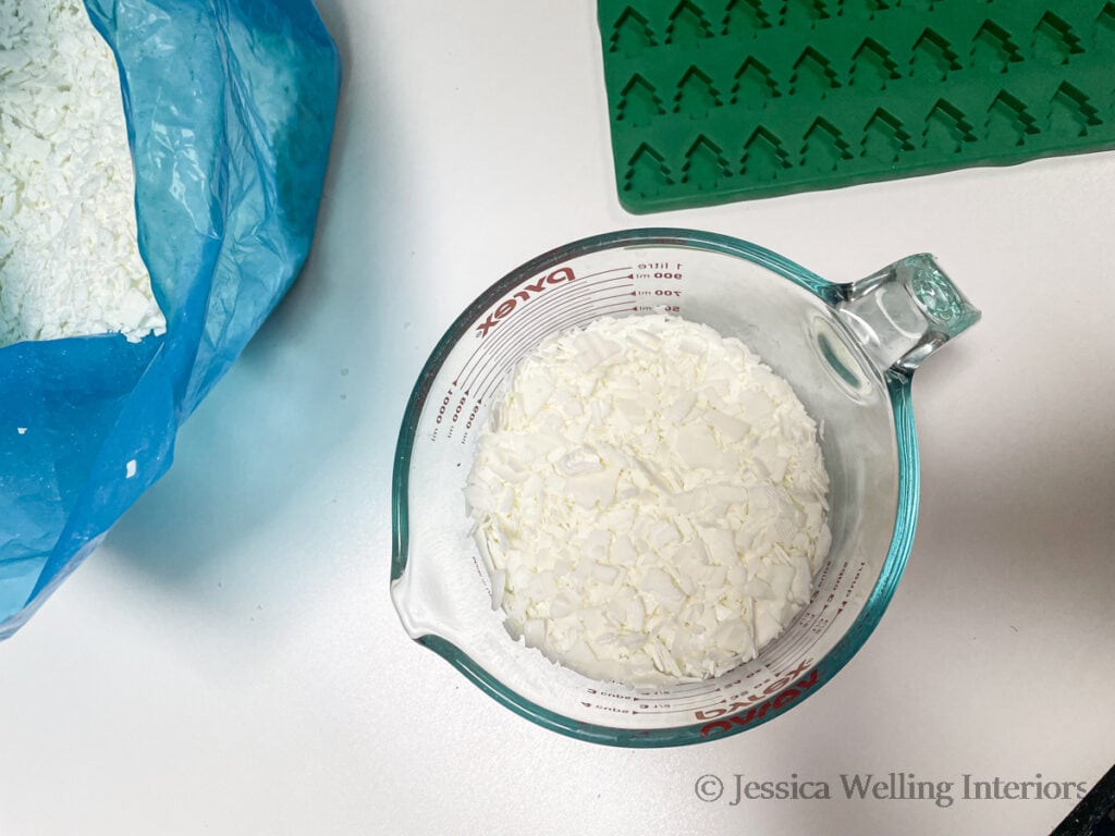 overhead view of pyrex measuring cup with 2 cups of soy wax flakes, ready to be melted