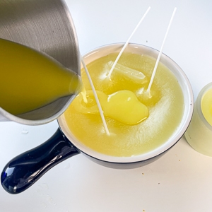 hot wax being poured to make a large citronella candle