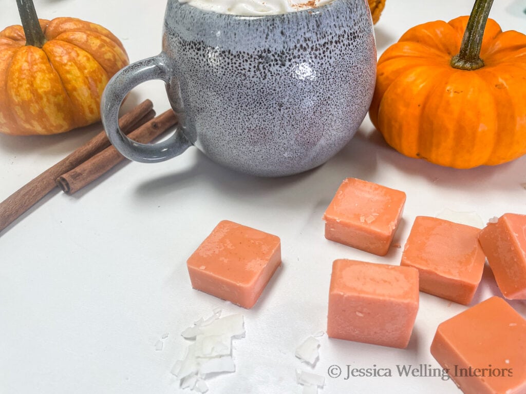 pumpkin spice-scented DIY was melts with pumpkins, a mug of coffee, and cinnamon sticks