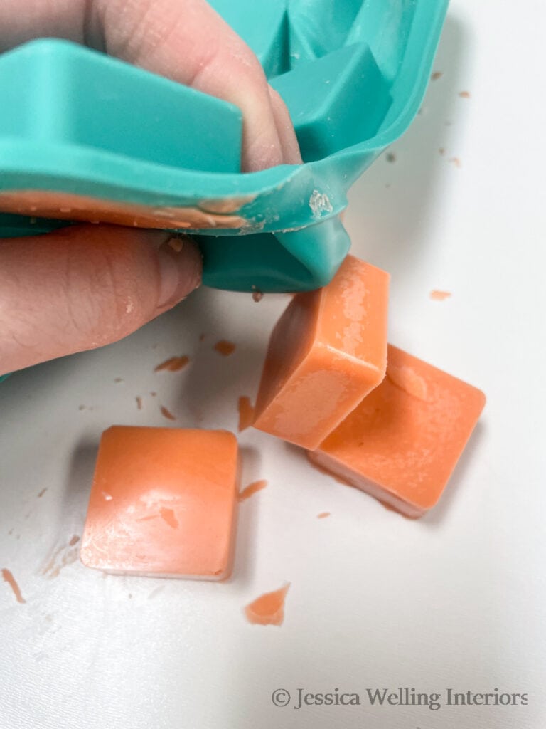 pumpkin scented wax melts being removed from a silicone wax melt mold