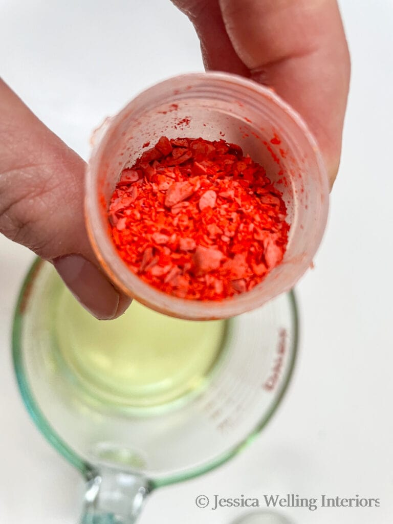 close-up of container of orange wax dye chips