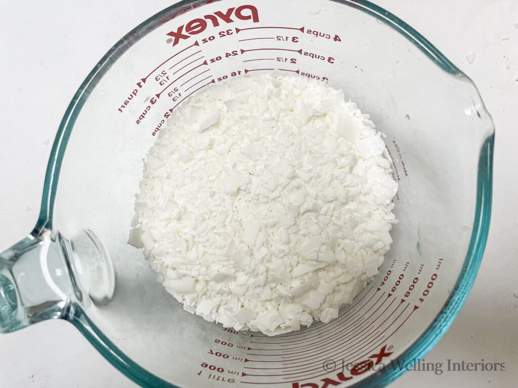 overhead view of large glass measuring cup of soy wax flakes