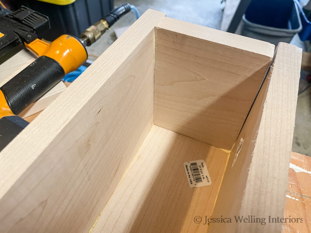 inside end of a DIY box beam mantel being assembled