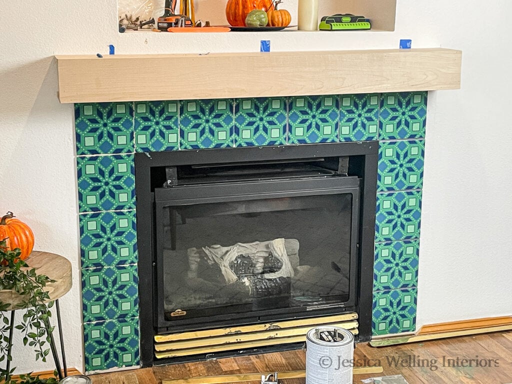 wood mantel mounted on the wall above the fireplace