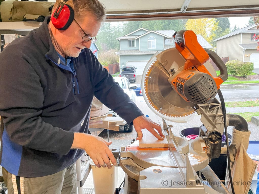 mantel board being cut with a miter saw