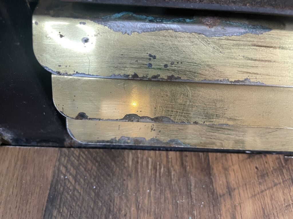 close-up of old gas fireplace insert with rusted vents