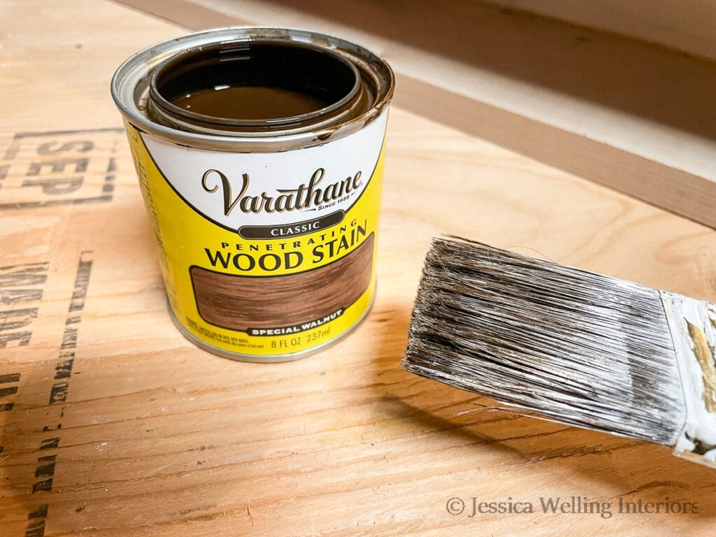 can of special walnut colored wood stain and a paintbrush
