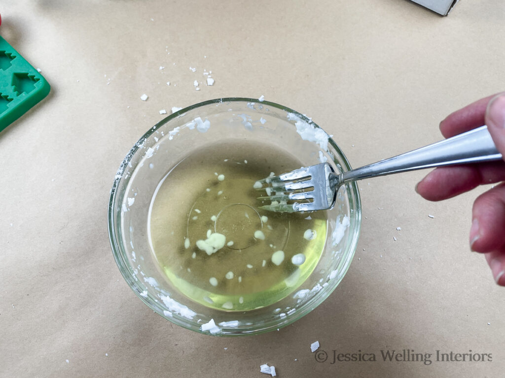 melted soy wax being stirred with a fork