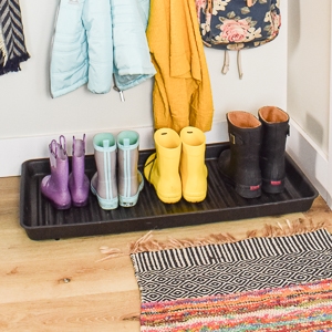 boot tray with boots lined up in an entryway