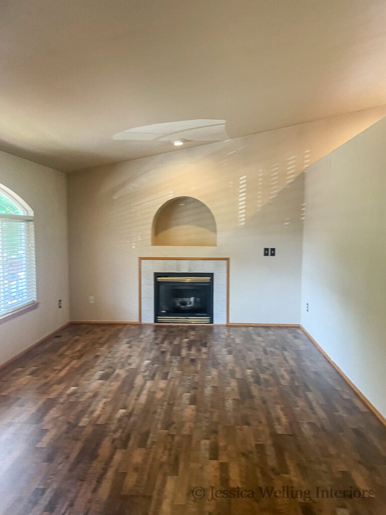 old fireplace with a tile fireplace surround in an empty living room