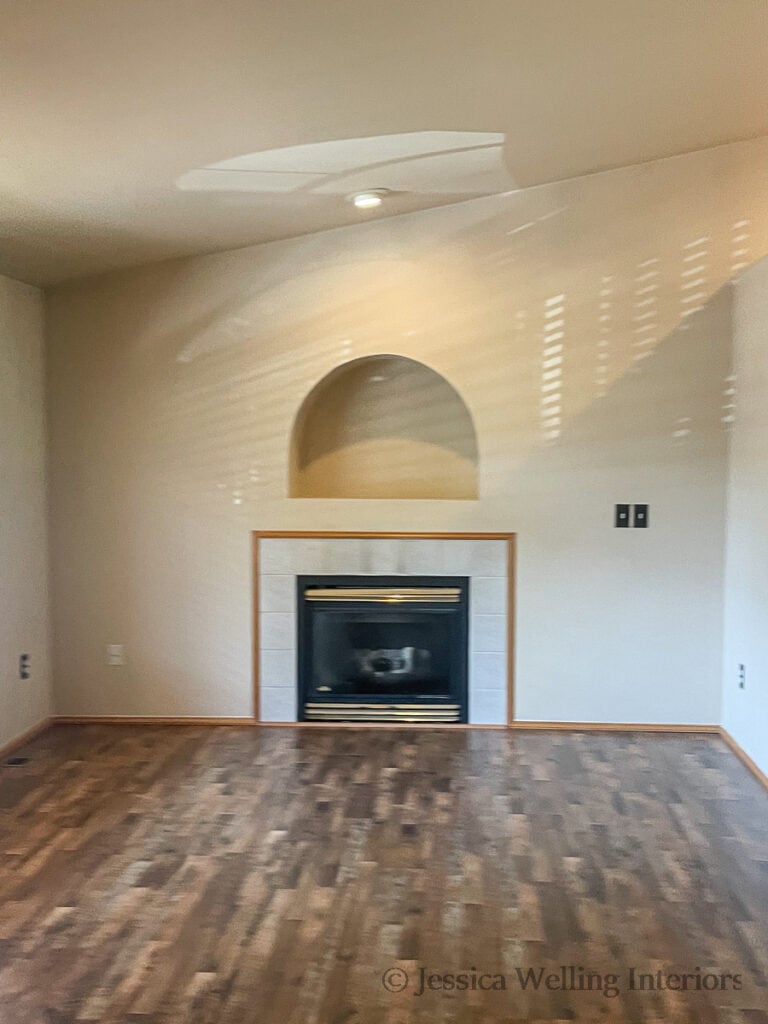 empty living room with a dated gas fireplace on one wall