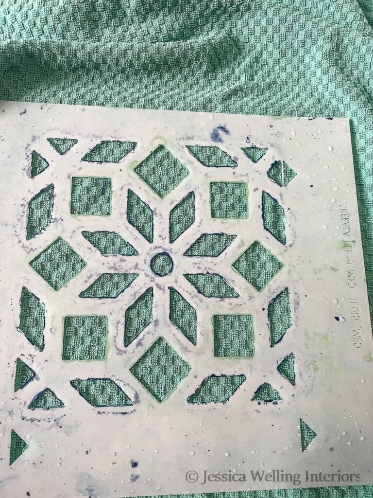Moroccan tile stencil being dried with a dish towel