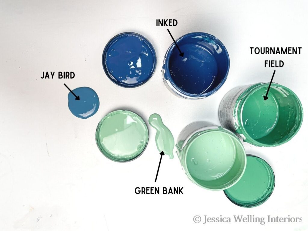 overhead view of 4 different paint sample colors used for painting fireplace tile: Behr Jay Bird, Inked, Tournament Field, and Green Bank