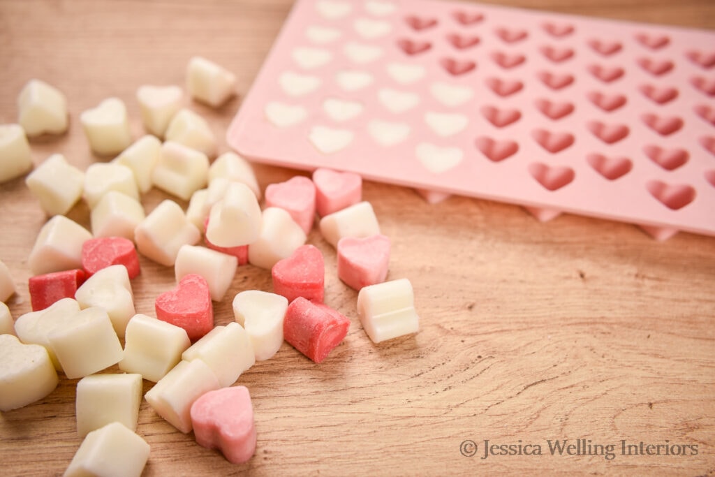 heart-shaped wax melts with a heart wax mold in the background