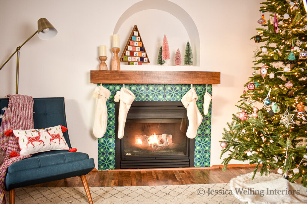 living room decorated for Christmas with plush White Chrismtas stockings hung over the fireplace