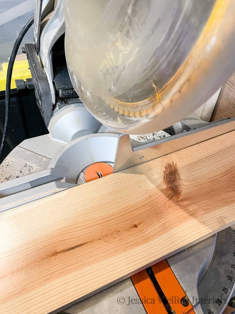2x8 board being cut with a miter saw to make DIY floating shelves