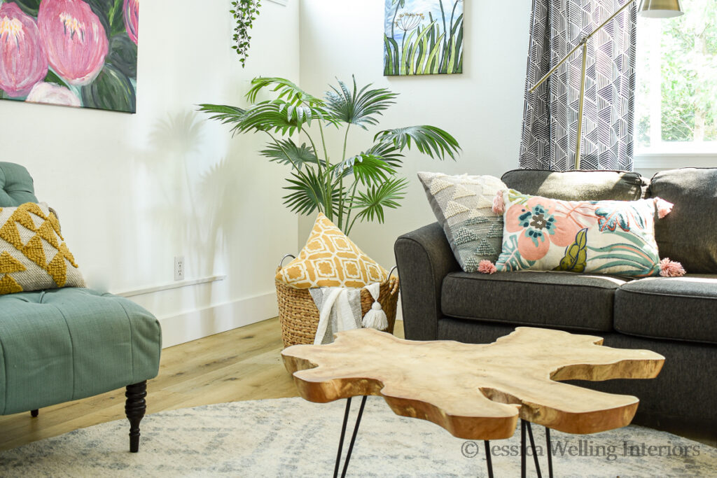 colorful living room with a round area rug under the sectional sofa and chairs