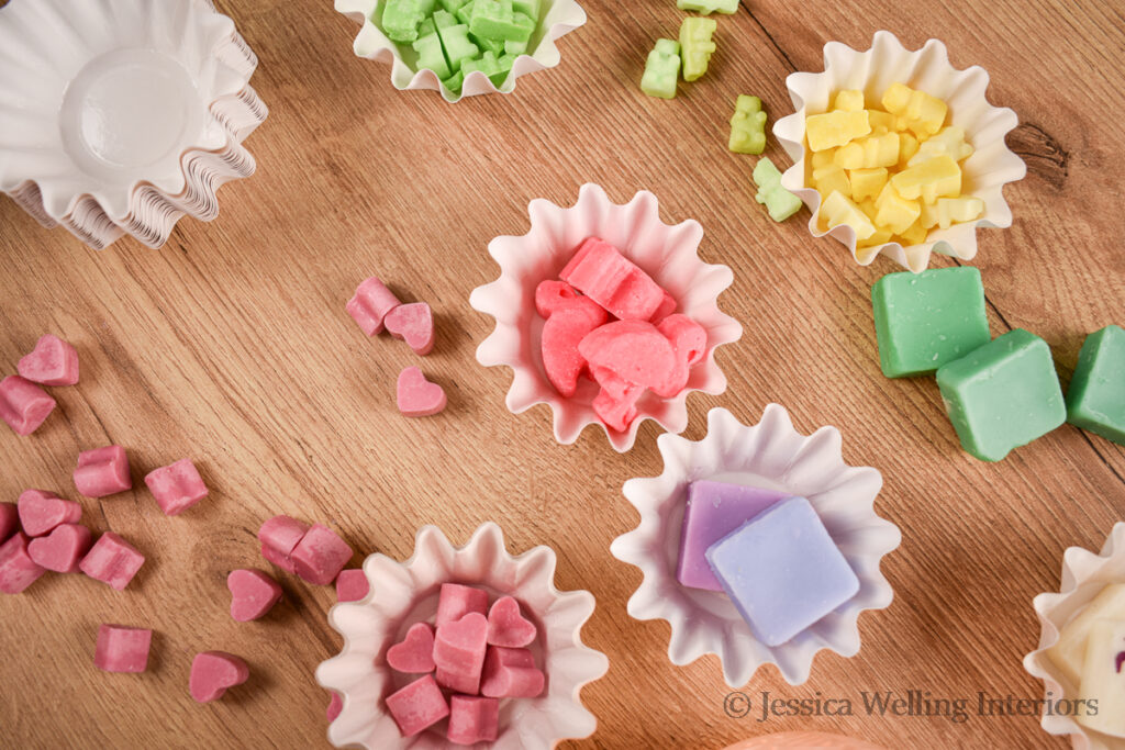 overhead view of a variety of different wax melts in paper wax melt liners
